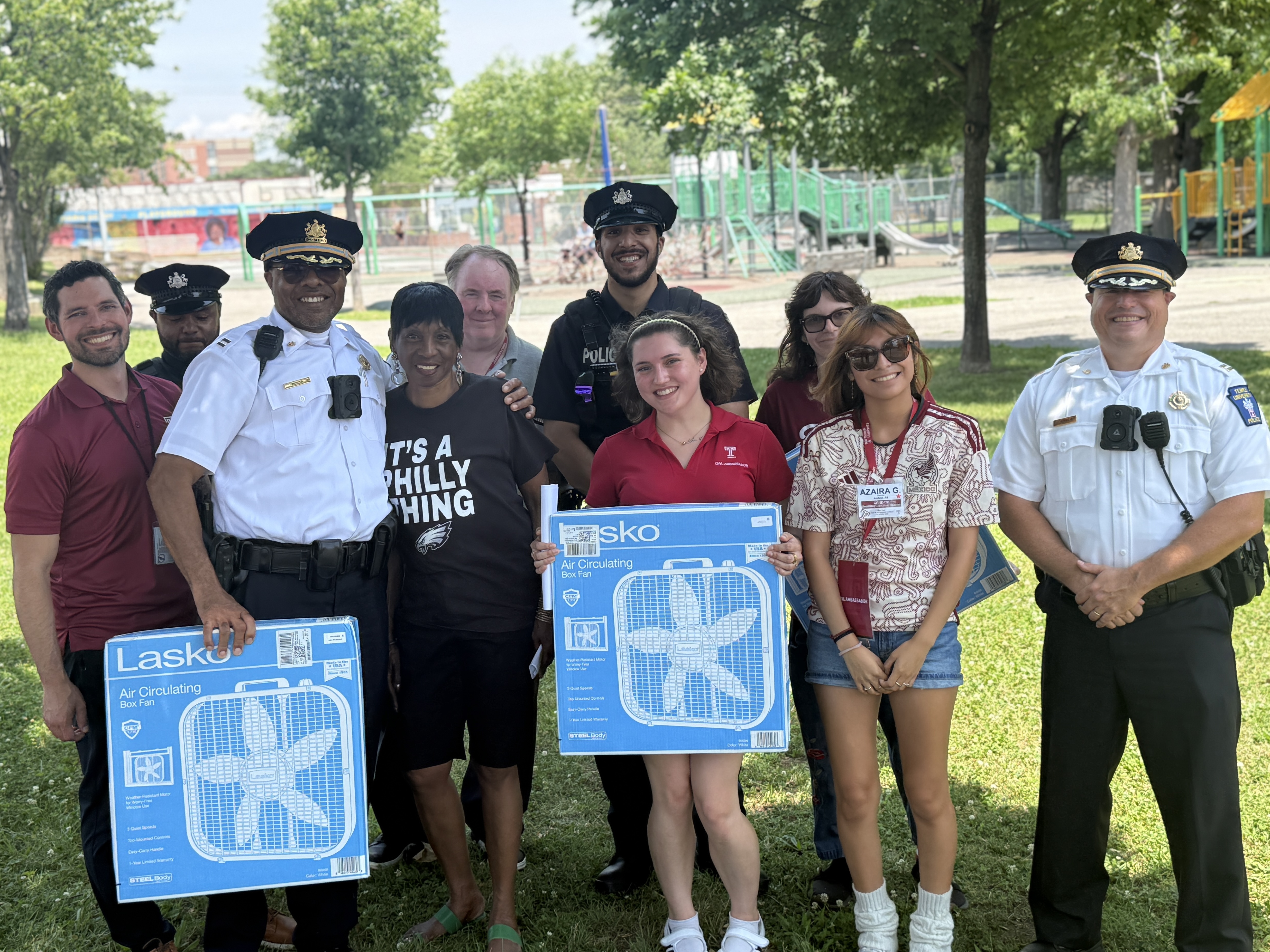 Temple Public Safety officers and students at fan giveaway