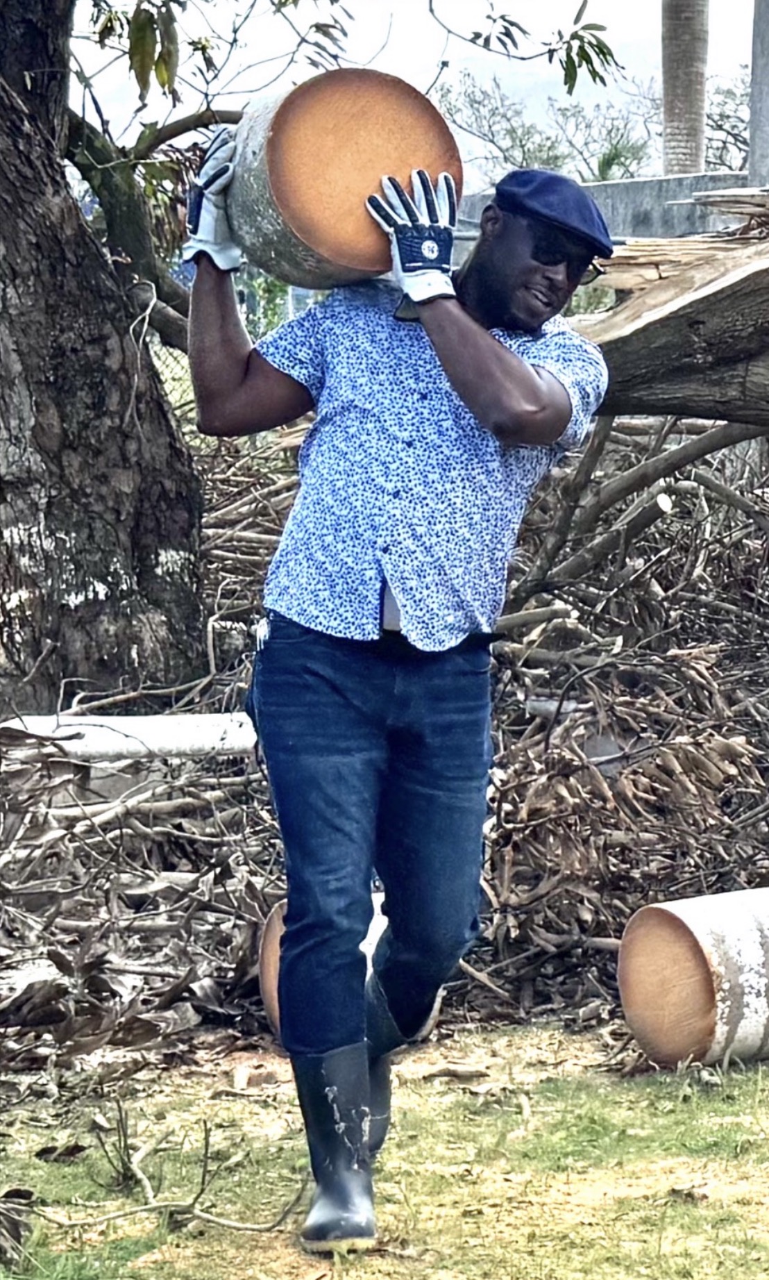Dr. Darien G. Henry removes a tree log from a debris field