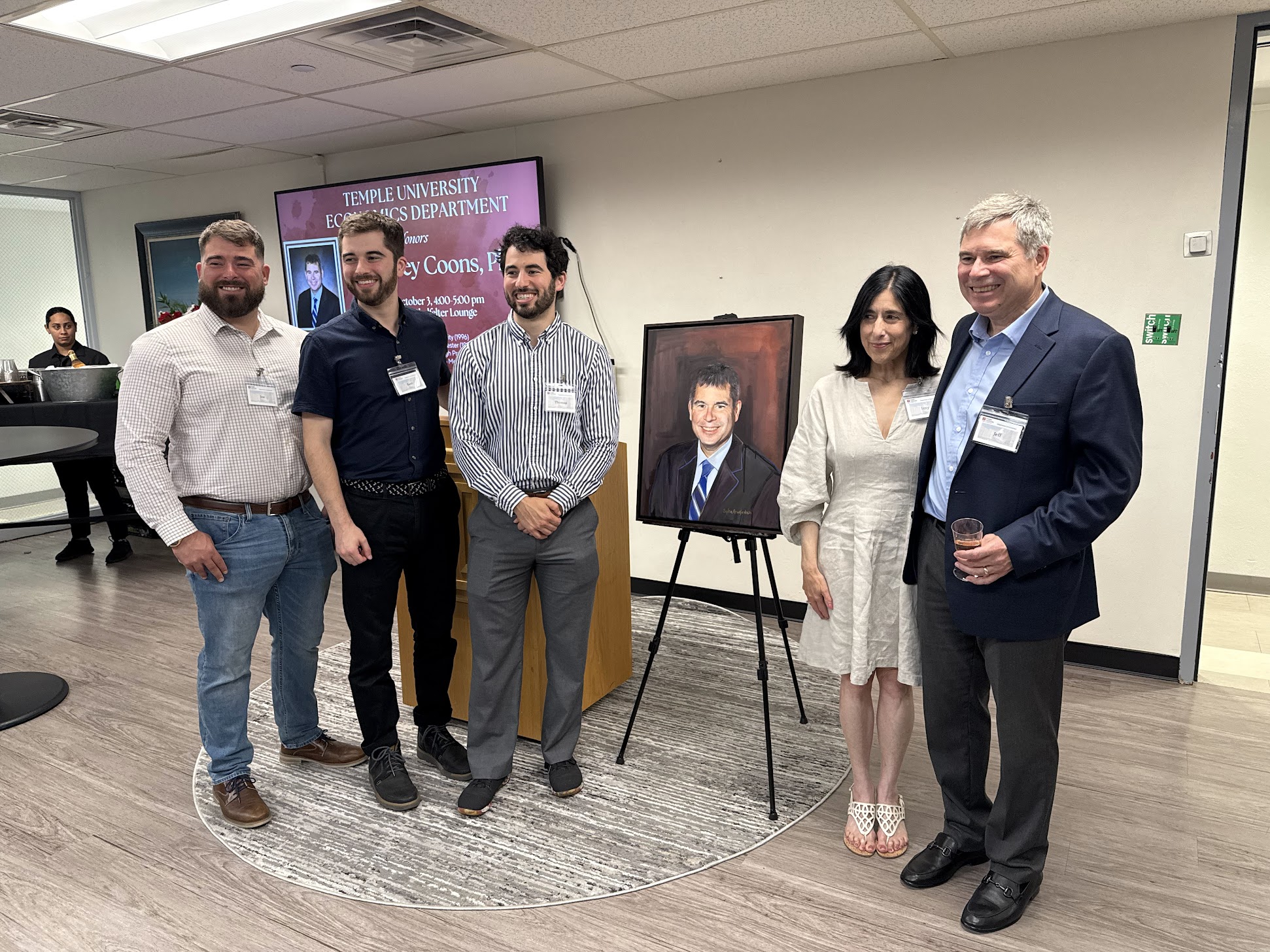 Dr. Coons, his wife and three sons pose with newly unveiled portrait