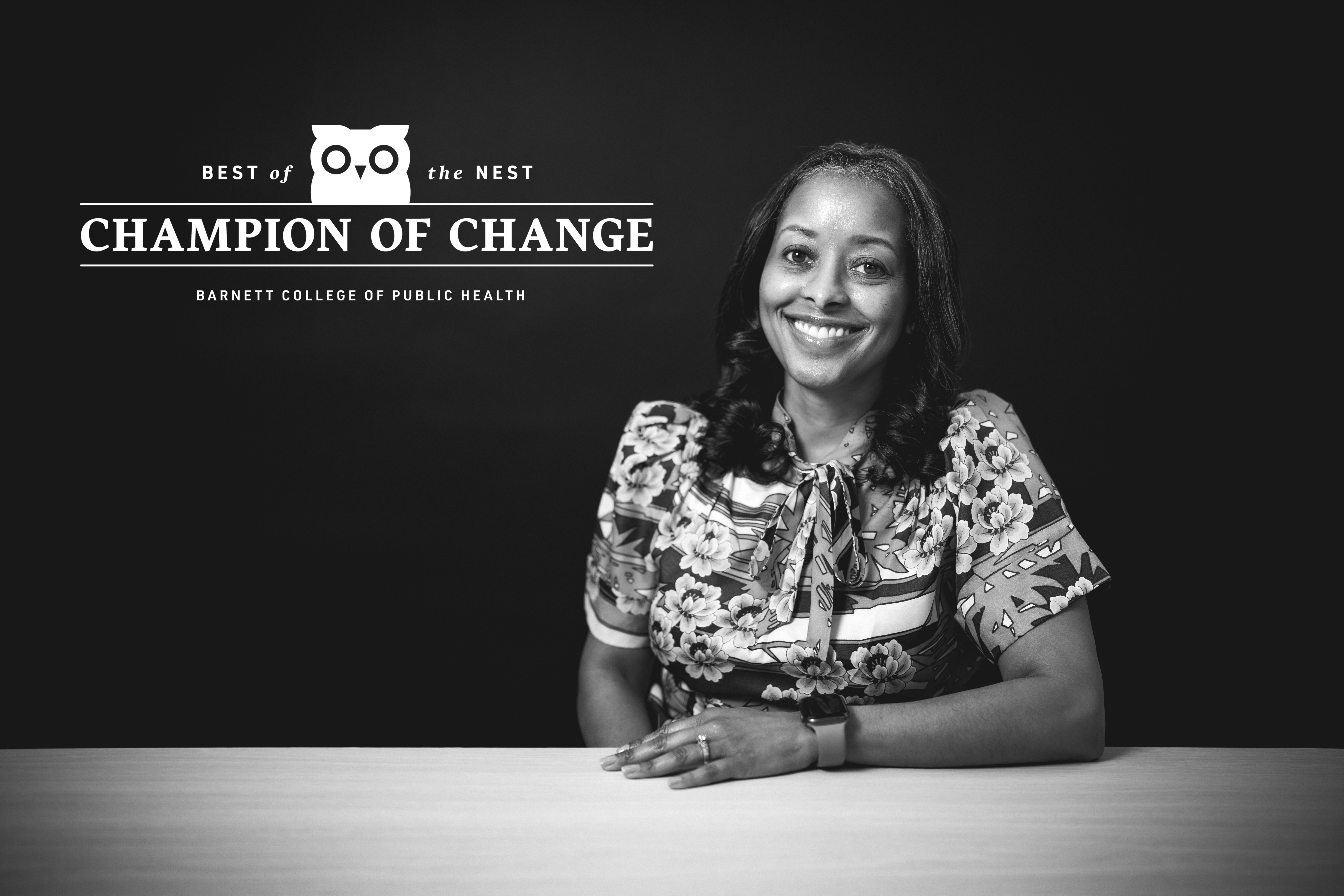 Black and white portrait of Kesa Bond, seated and smiling.