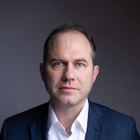 Dr. Preston in a blue suit and a white shirt