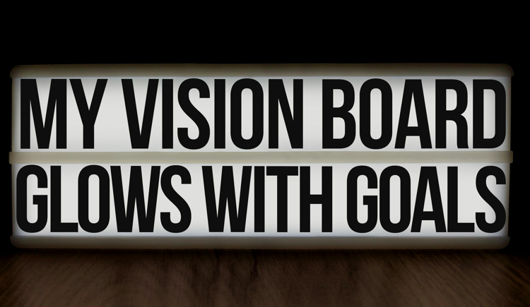 A board spelling out the quote: My vision board glows with goals
