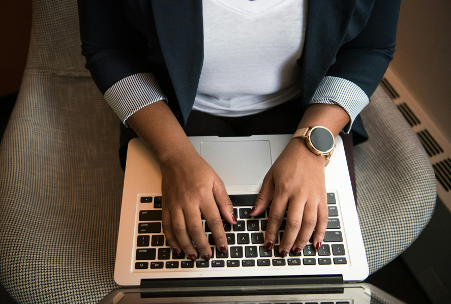 Person typing on a Macbook 