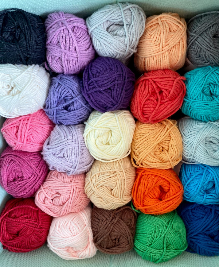 Five rows of yarn in a variety of colors. 
