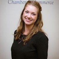 headshot of Suzanne wearing a black top smiling at the camera