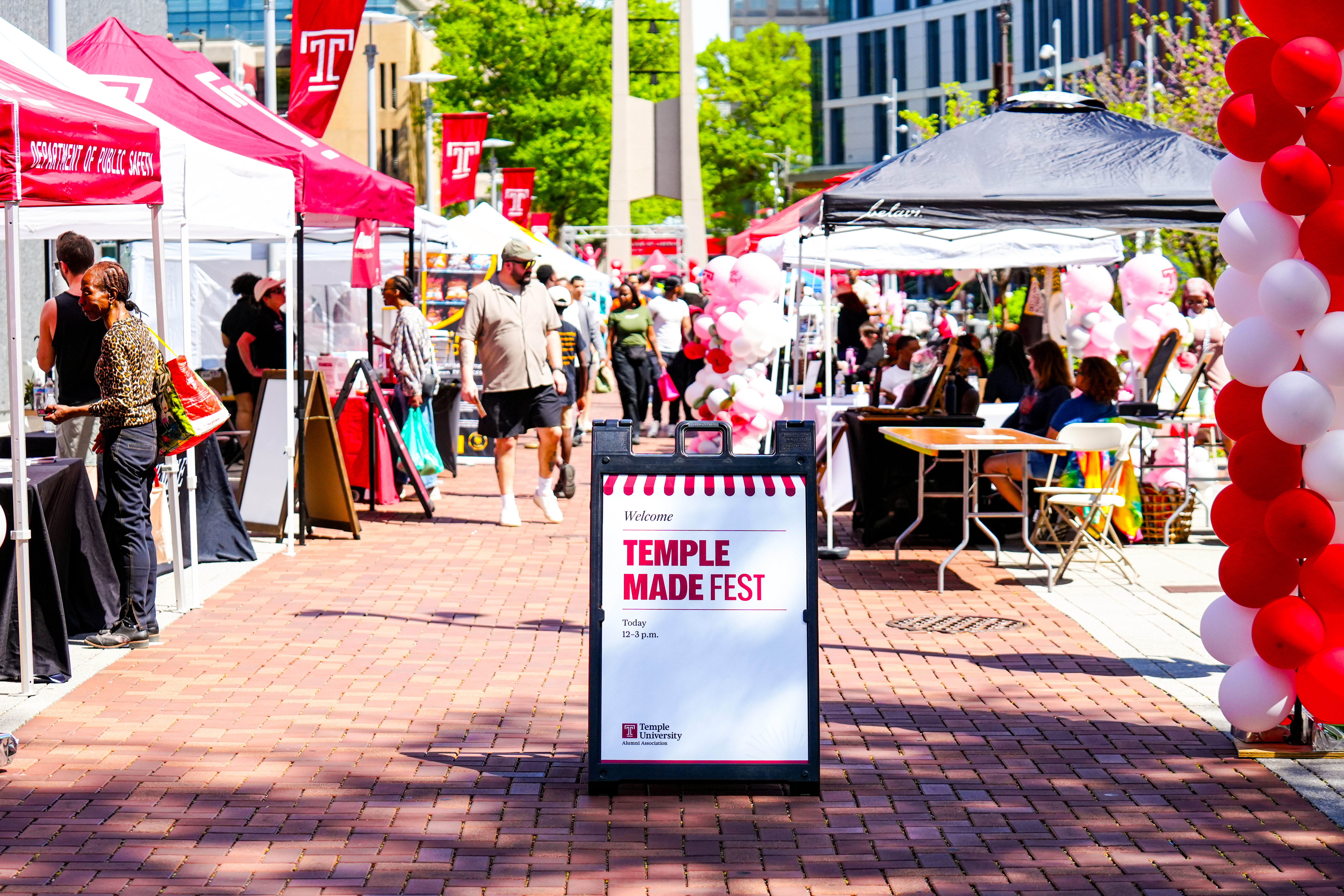 Vendors and shoppers are pictured by the Temple Bell Tower during Temple Made Fest.