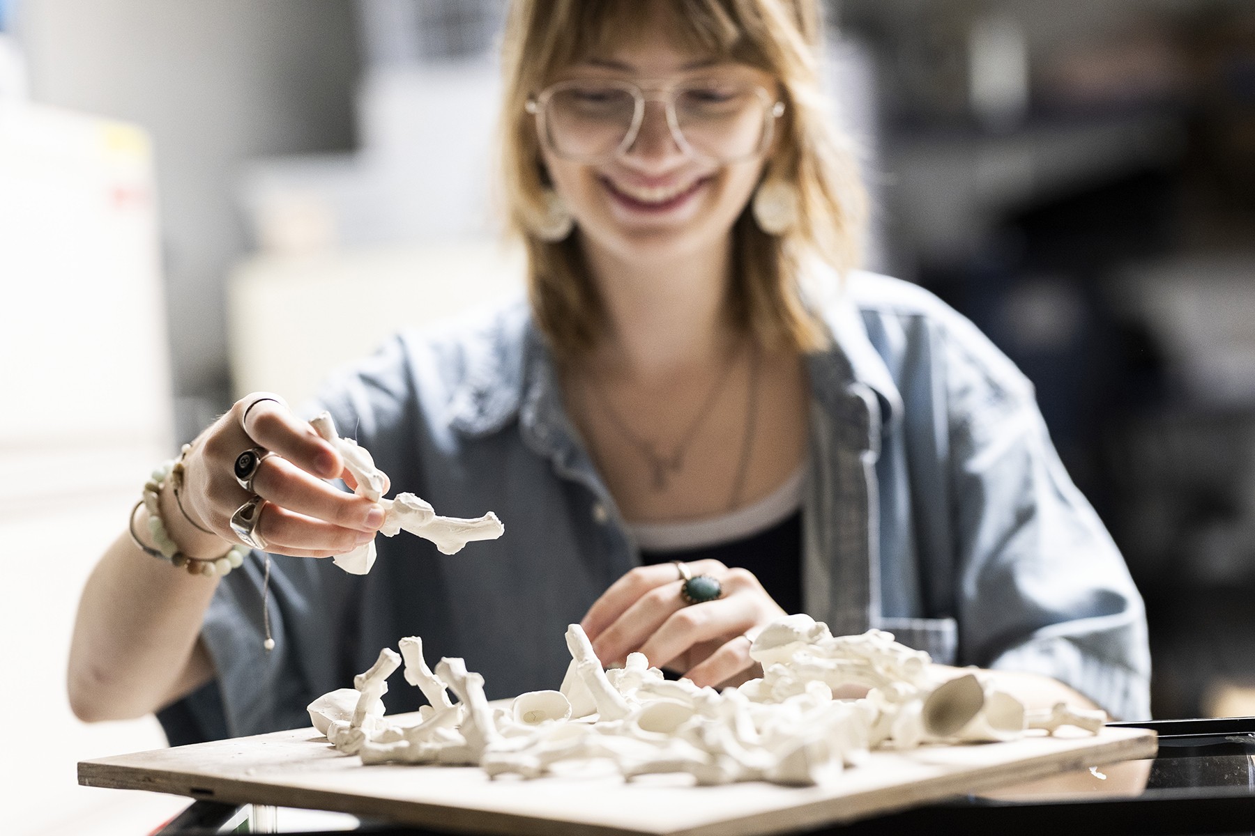 Eva Close, Class of 2027, looks through her self-made porcelain corals, which she created through Temple’s Diamond Research Scholars Program.