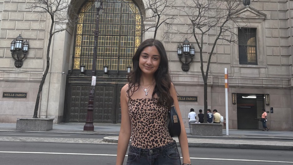 Jasmine Mehta standing in front of Wells Fargo building.