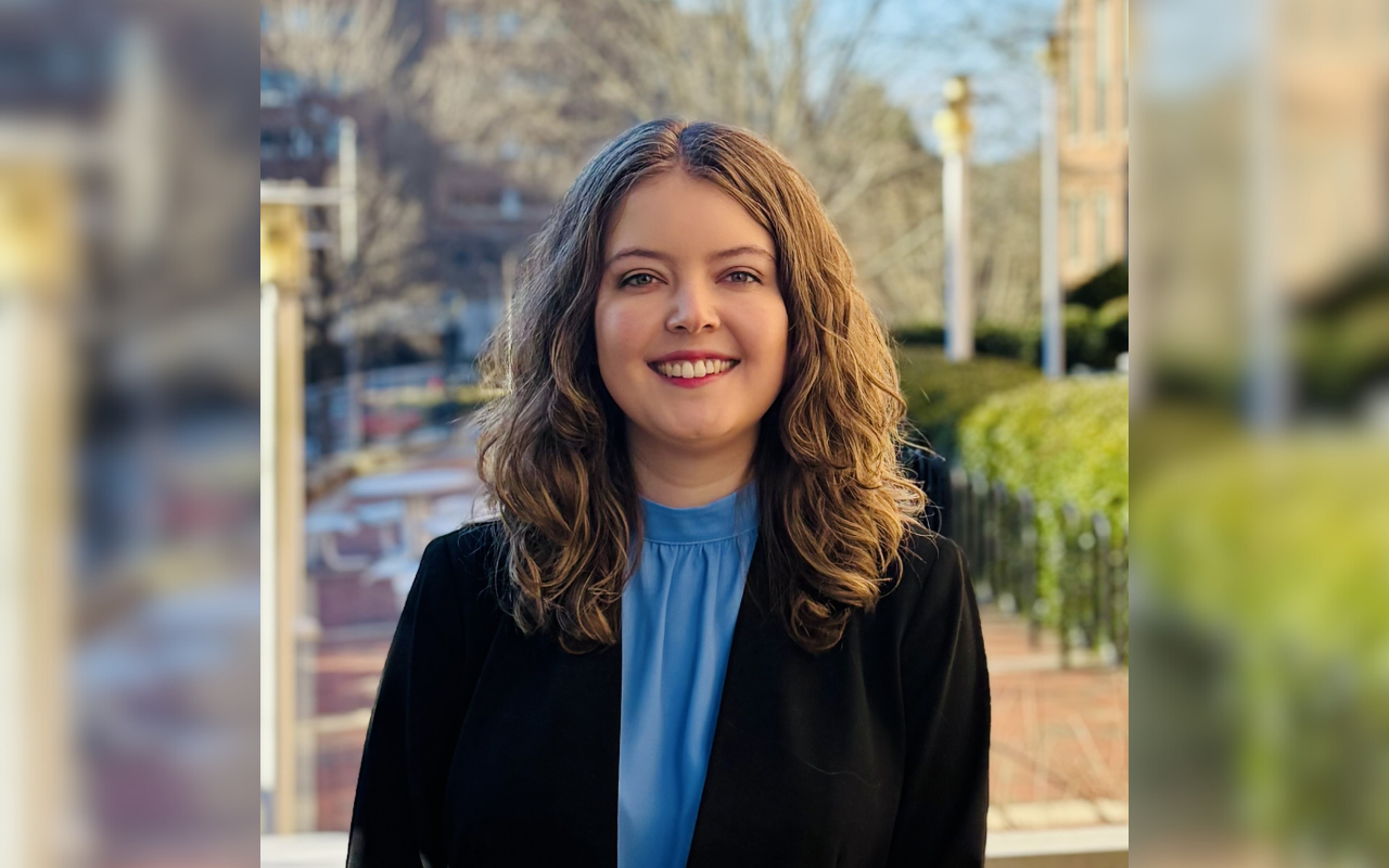 Close up of a woman with light skin and dark hair smiling