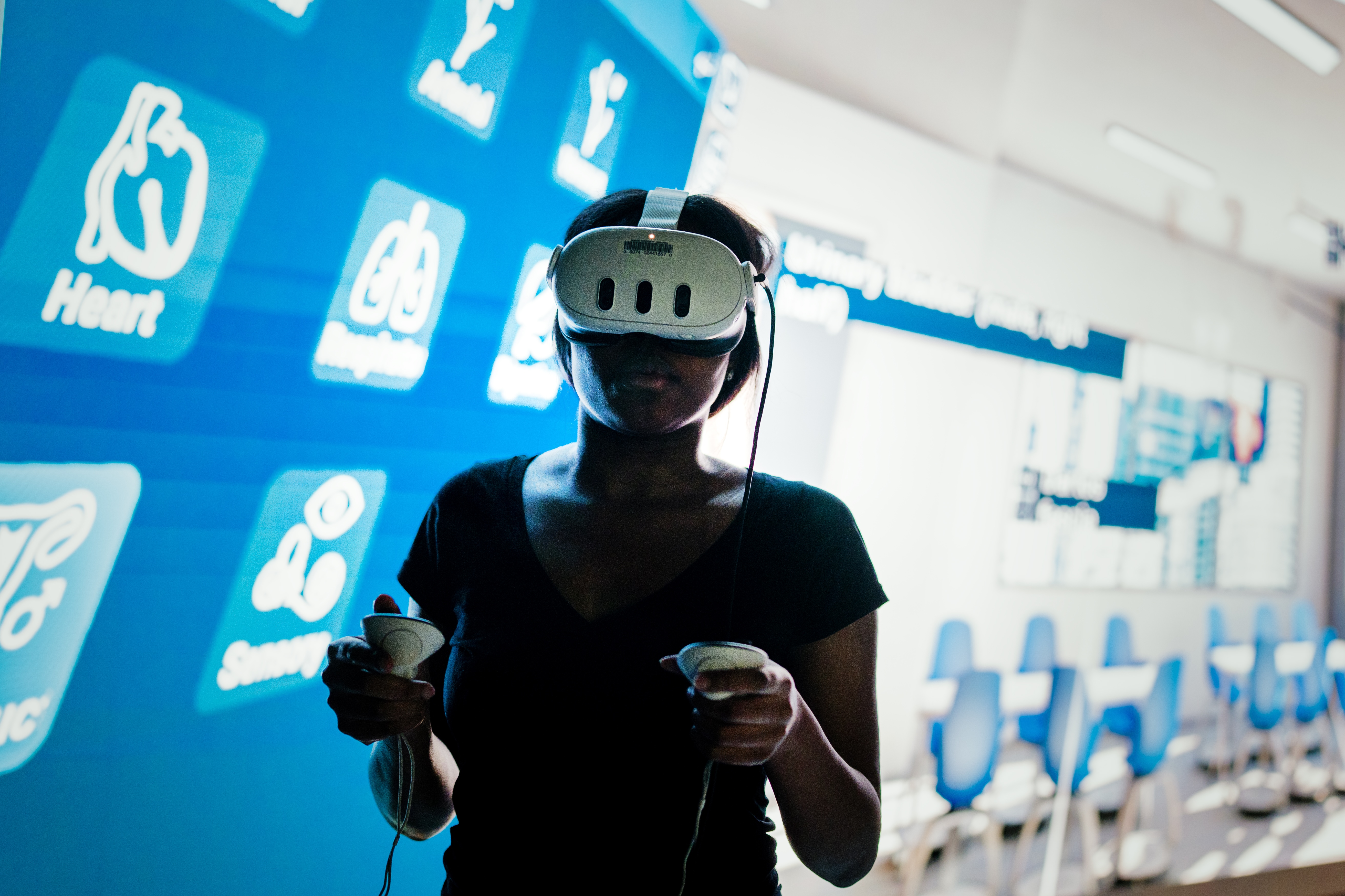 Student wearing VR headset practices using Organon Anatomy VR software.