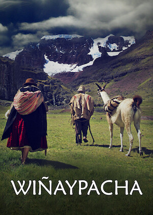 Back of two figures walking in green path through mountains in background. They are walking with a Llama.