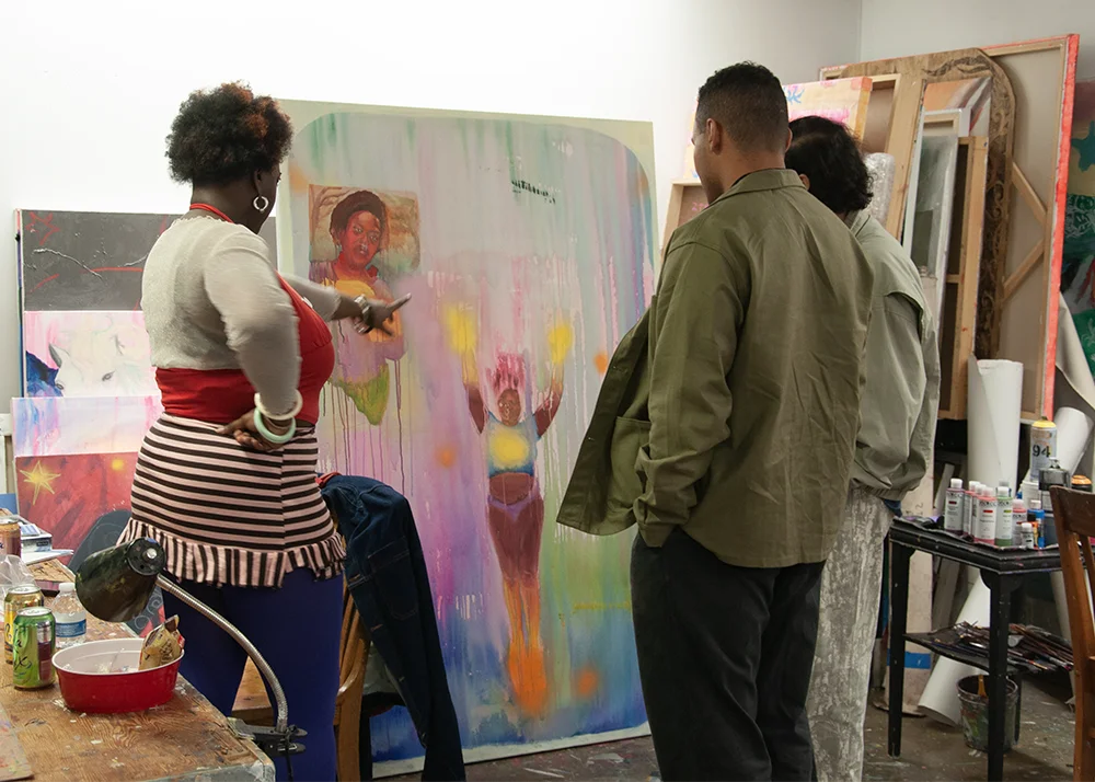 an artist shares their works-in-progress with visitors at the 2025 MFA Open Studio event