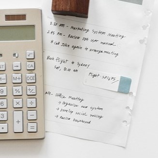 A calculator next to a sheet of paper.