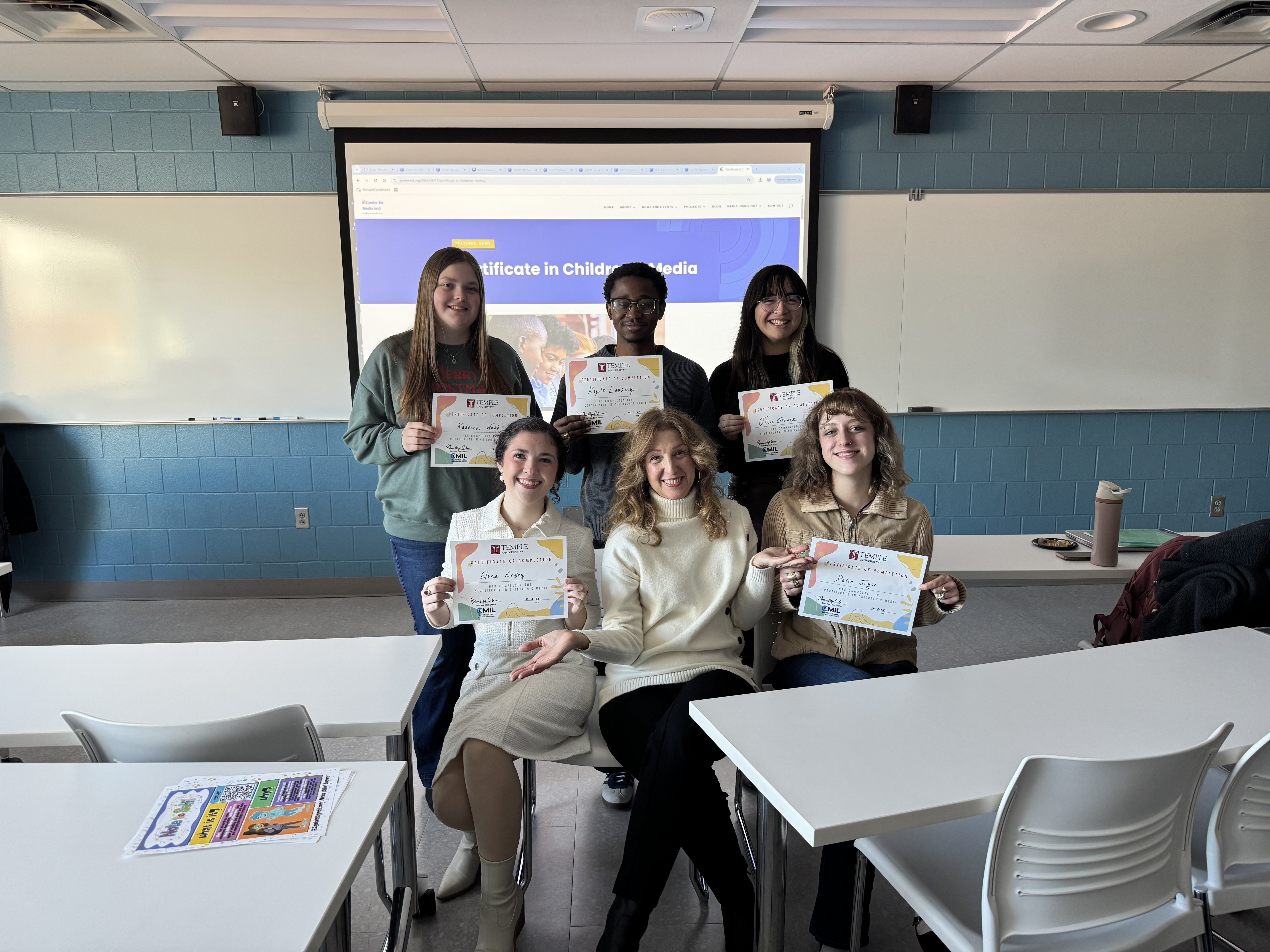 Students holding certificates