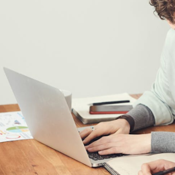 A clinical supervisor working at a laptop