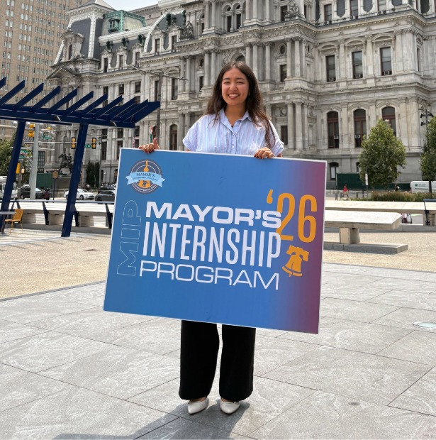 Luana poses in front of City Hall with Mayor's Internship Program '26 sign