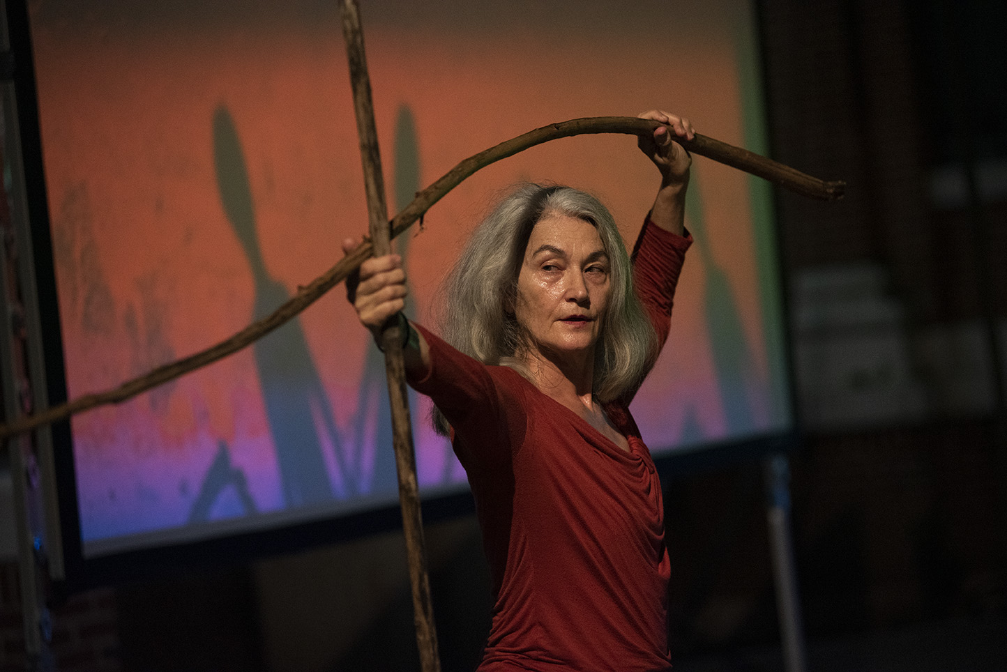 Meri n Soto holding branches as part of her choreography