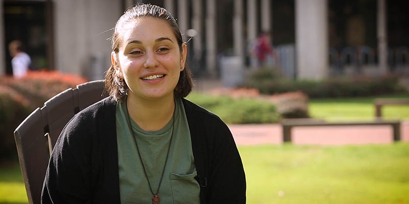 Nadia Vanessa Toro sitting with Paley Library in the background.
