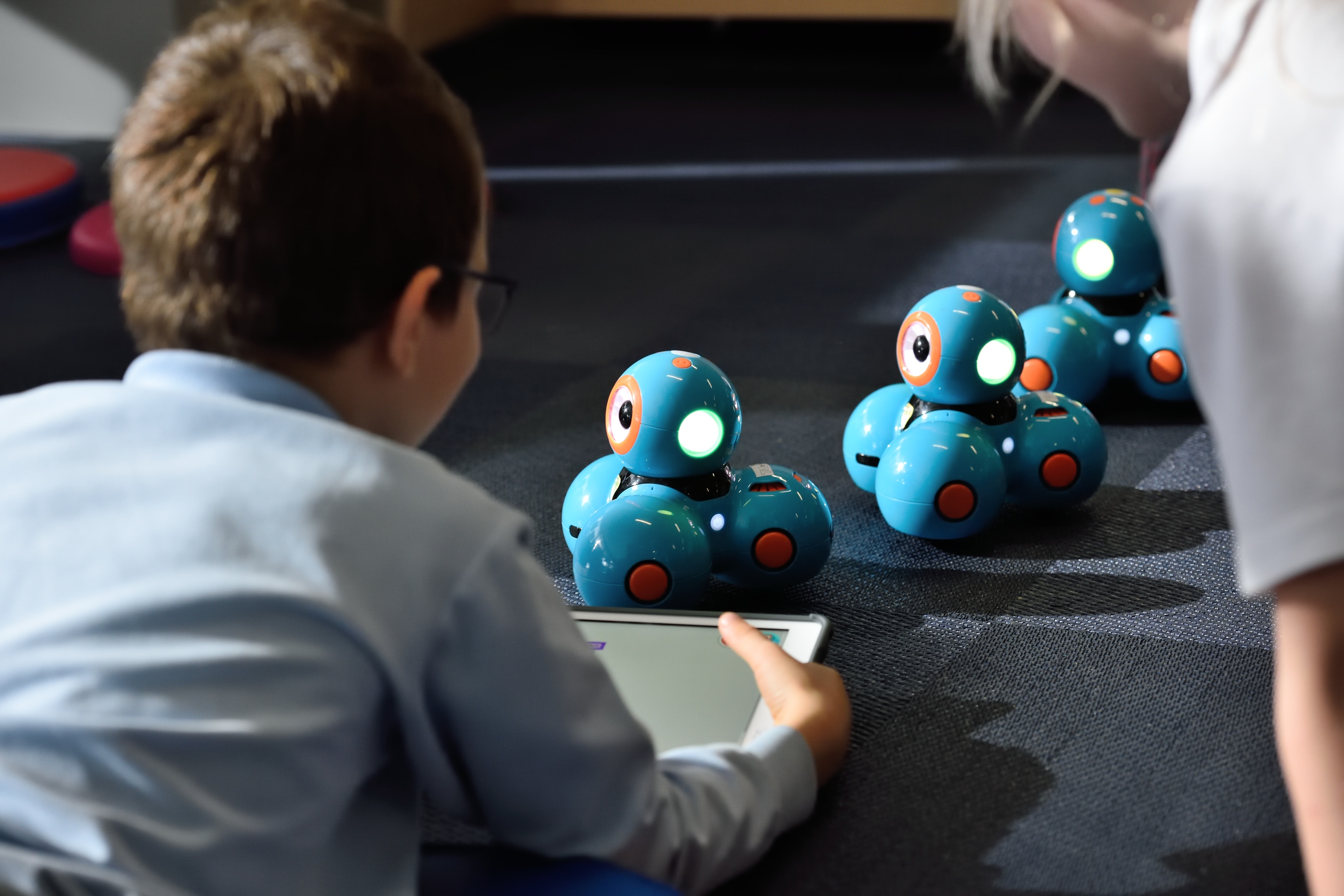 Image of a child playing with robot toys.