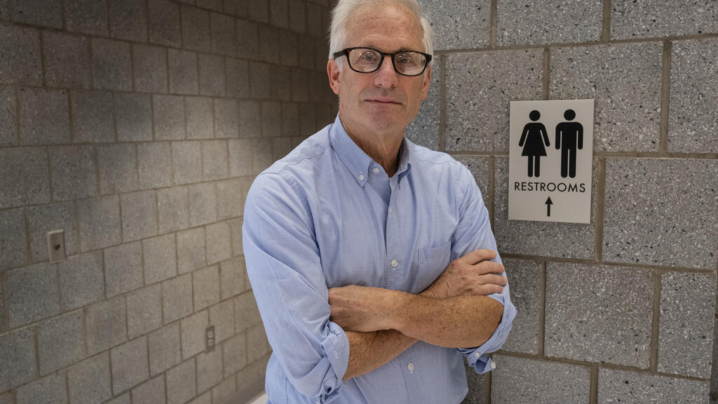 A photo of Bryant Simon outside a public restroom.