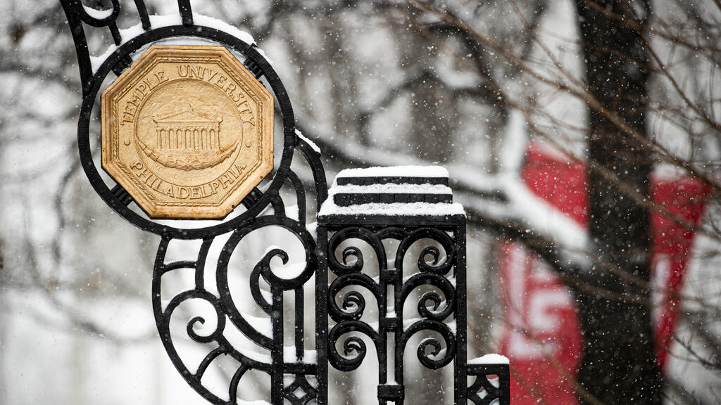 A Temple sign at the gate on Main Campus in the winter