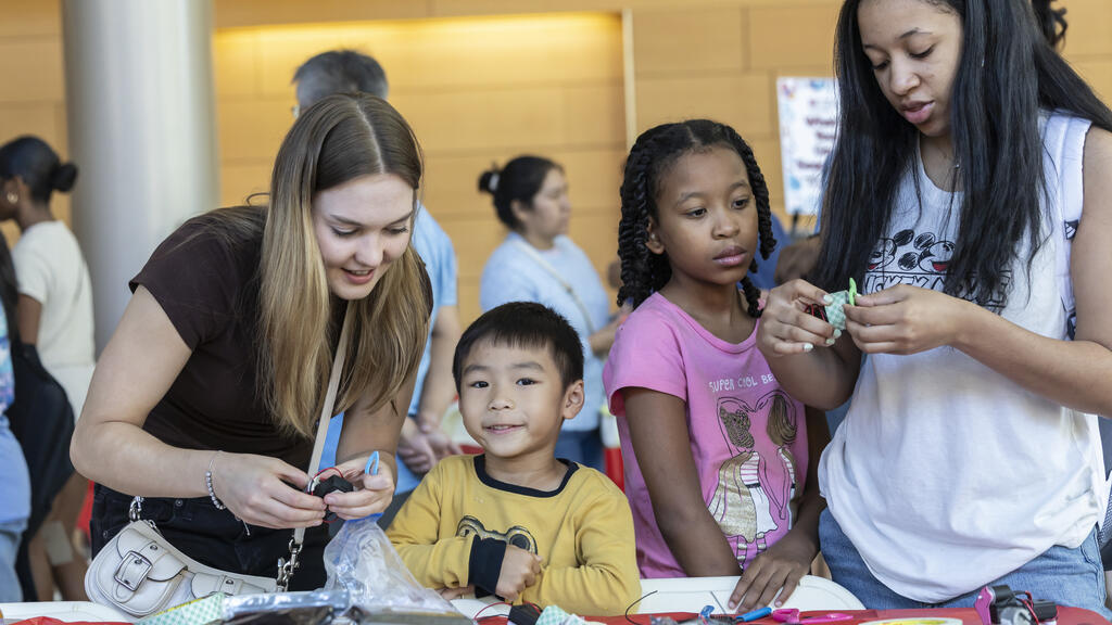 Image of attendees working at a work station during the STEMM Fair.