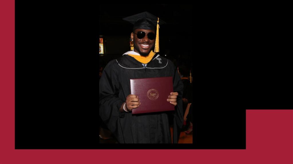 Daniel in his cap and gown after receiving his PSM.