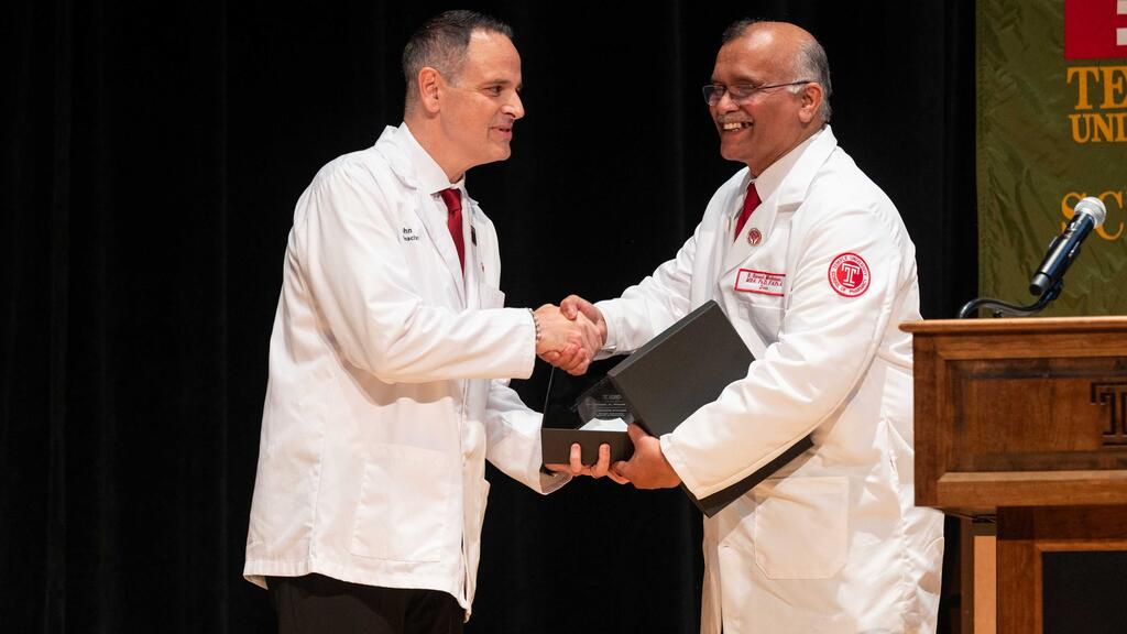 John Colaizzi and S. Suresh Madhavan interact during the ceremony.