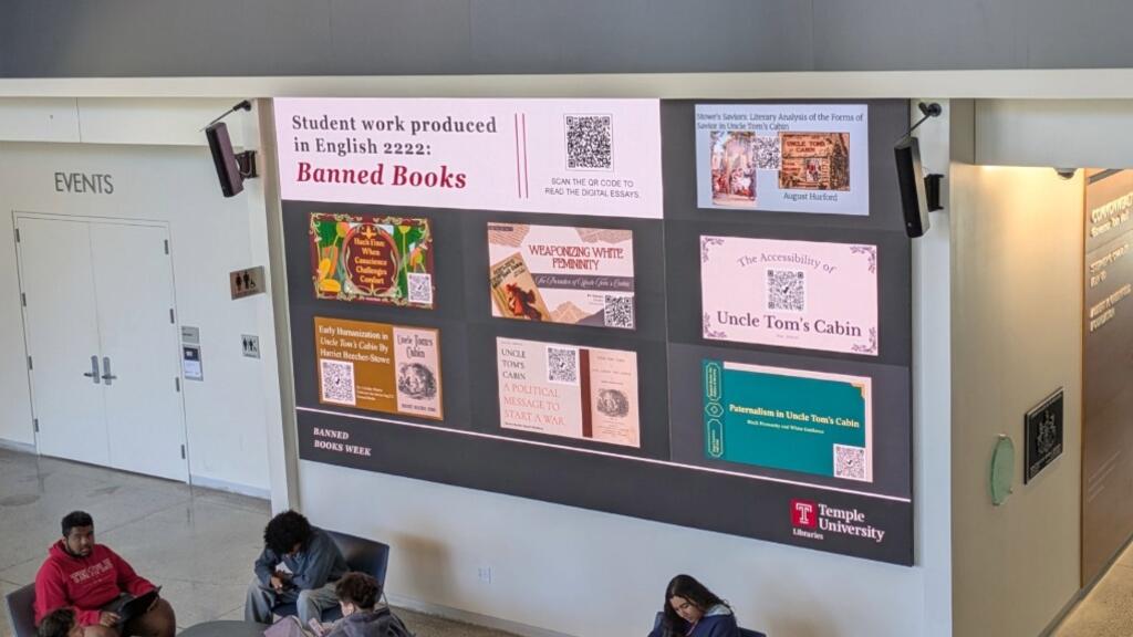 Charles Library displays student projects on first floor screen. 