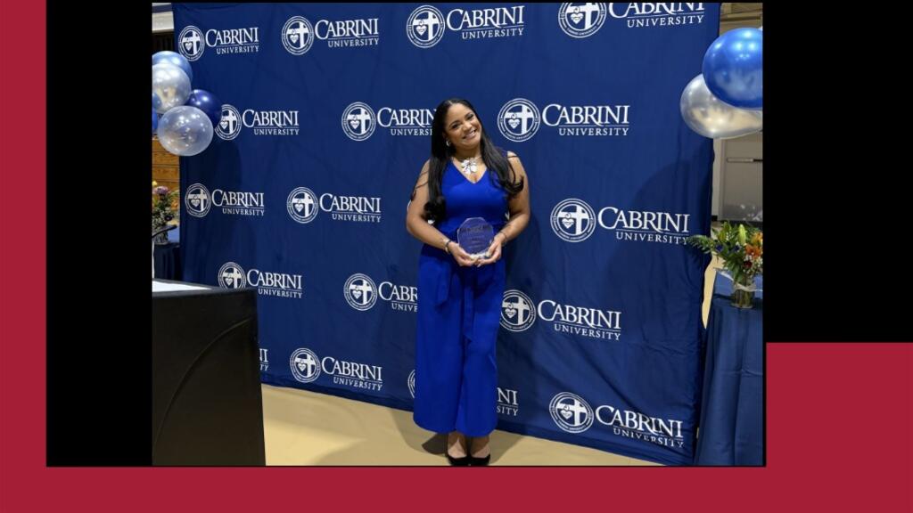 Mariel receives her award from Cabrini