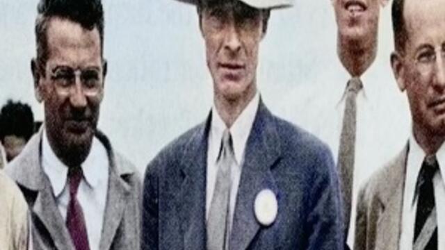 image of Oppenheimer wearing a tan hat and suit standing with other men in suits