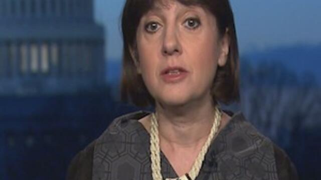 image of Olya Oliker in a grey suit talking on a CNBC interview