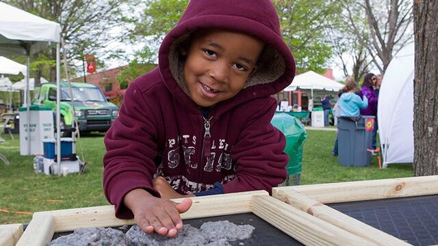 A child plays outside at Temple s Earth Fest.