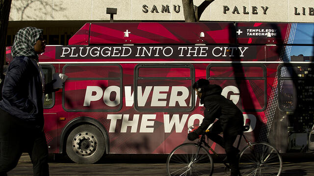 A Temple bus wrap that reads plugged into the city, powering the world outside of Paley library.