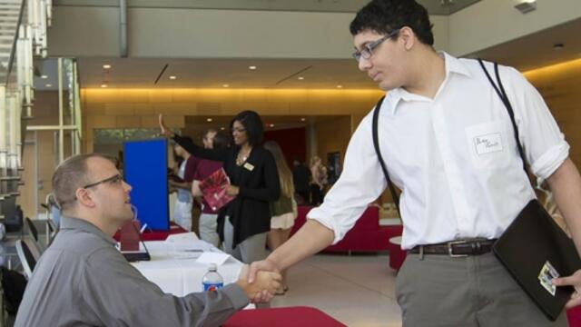 Student shaking hands with potential employer.