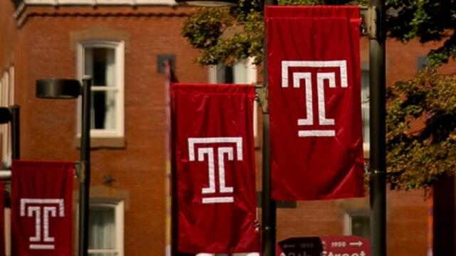 Four Temple T flags on Main Campus.