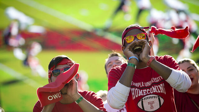 Two students cheering at a football game.