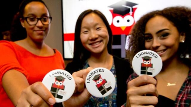 Temple students show off their I donated buttons at the Senior Class Gift launch party.