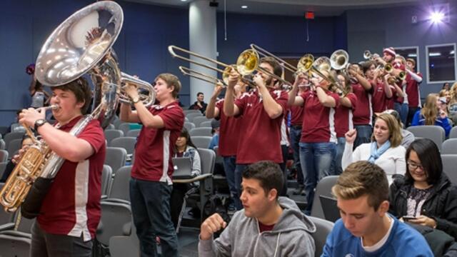 The Temple marching band playing in a lecture hall during pop-up pride celebration.