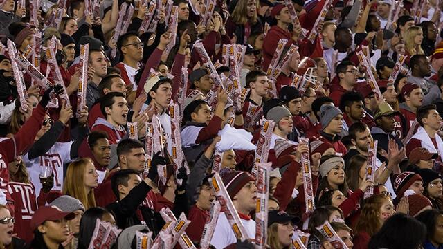 Crowds cheering at a Temple University football game.