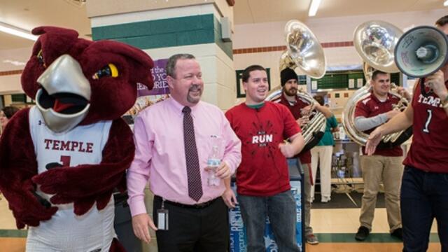 Ken and Kevin Acker celebrating with Hooter at a pop-up pride event.