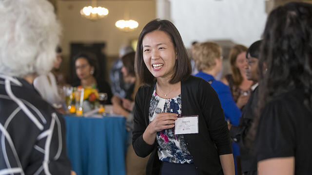 New and current faculty members talking.