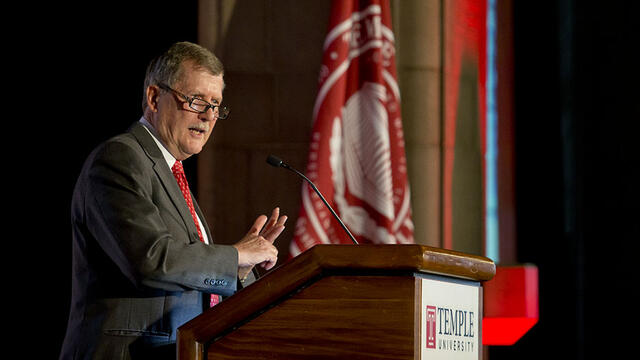 Acting President Richard Englert talking at a podium.