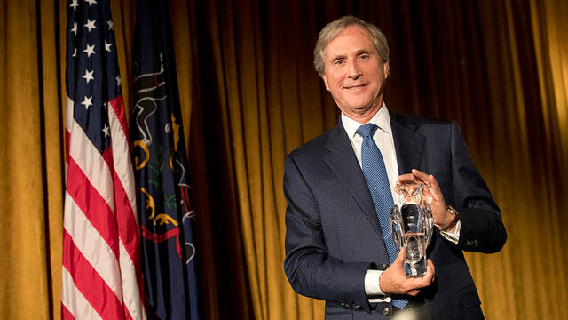 Musser Award recipient Gerard Sweeney holding his award.