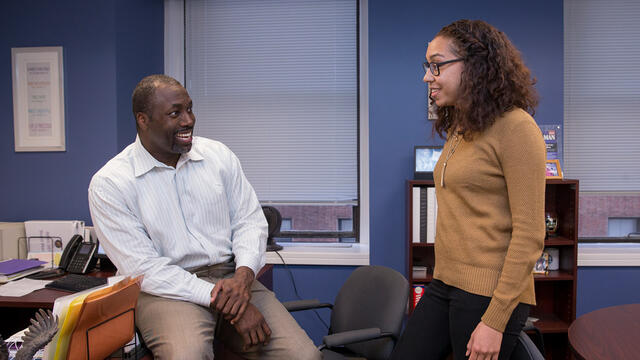 Marcus Allen, CEO of Big Brothers Big Sisters Independence Region, talking to an employee