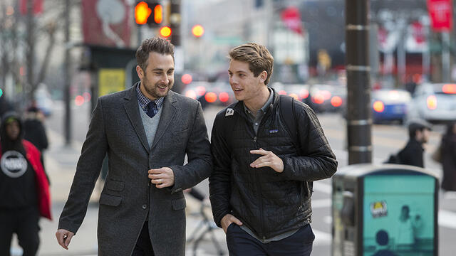 Justin Miller and Alex Cagle talking as they walk on Broad Street.