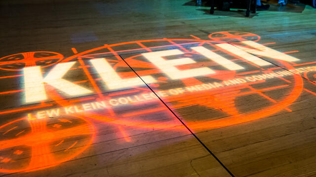Klein College s logo projected onto a stage