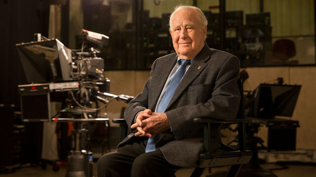 Lew Klein sitting in a TV studio