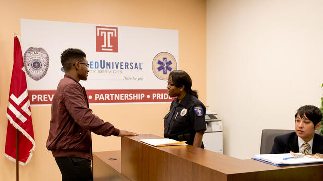 A man talking with a police officer inside the new station