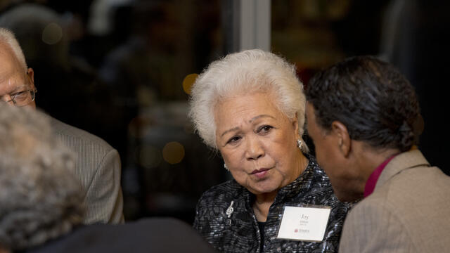 Image of Joy Abbott speaking with other people.